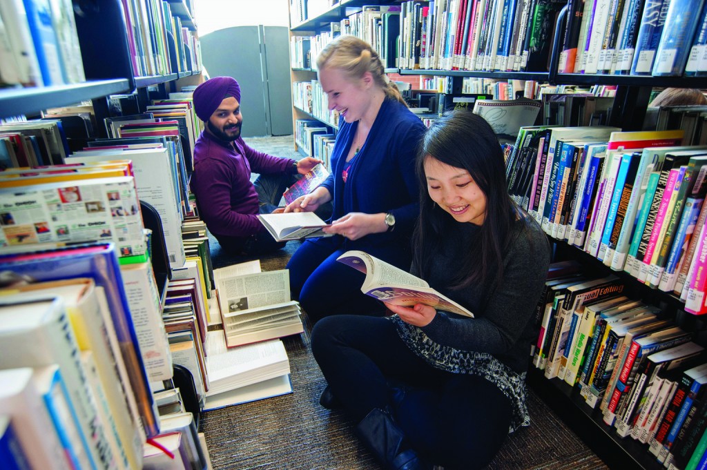 3 Georgian College students reading library books
