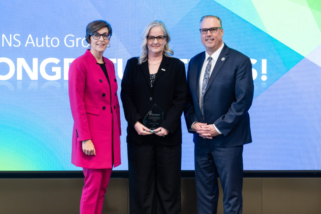 WEINS Auto Group members accept Community Partner Award.