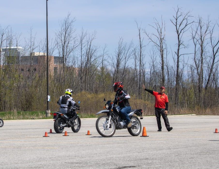 one instructor and 2 students in a parking lot