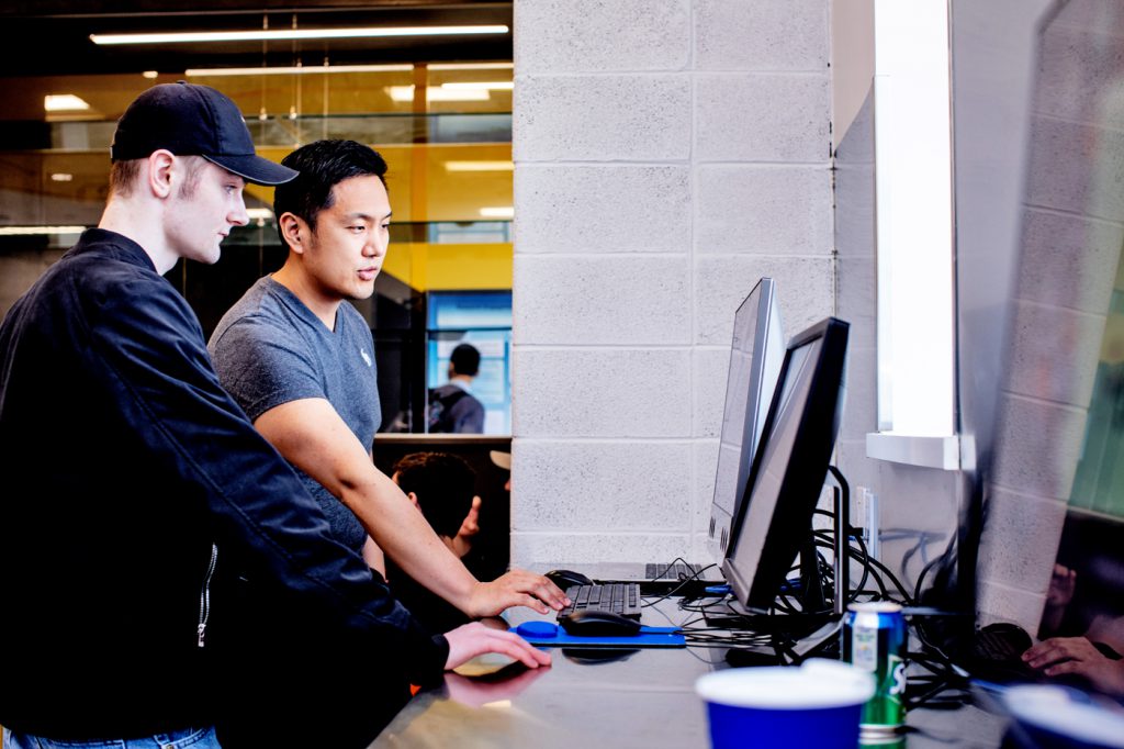 student researchers working on computer