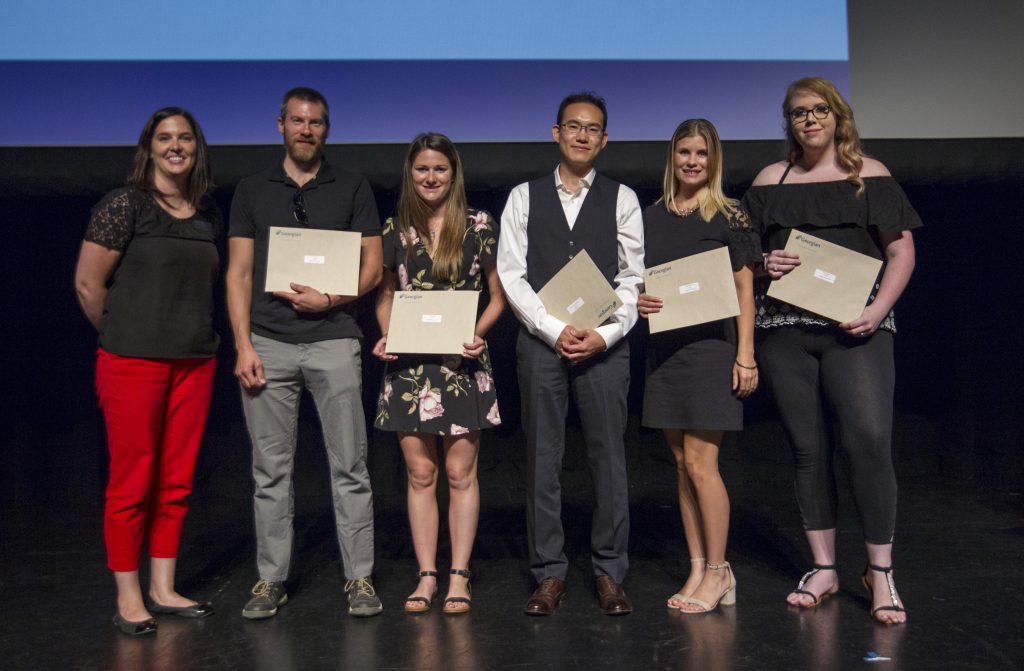 Students on stage with their awards