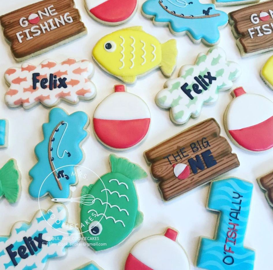 Aerial view of sugar cookies decorated with fish and fishing designs.