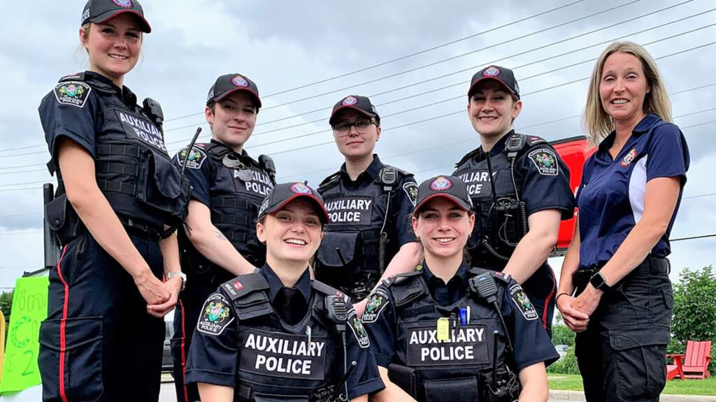 Group of female Honours Bachelor of Police Studies students post while at community event as auxiliary officers. 