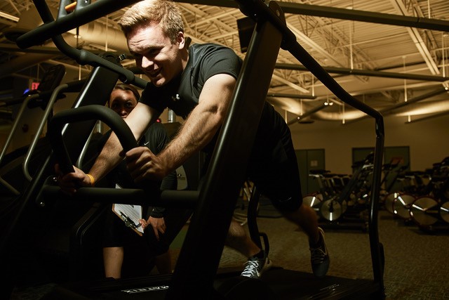 A young man on a piece of exercise equipment