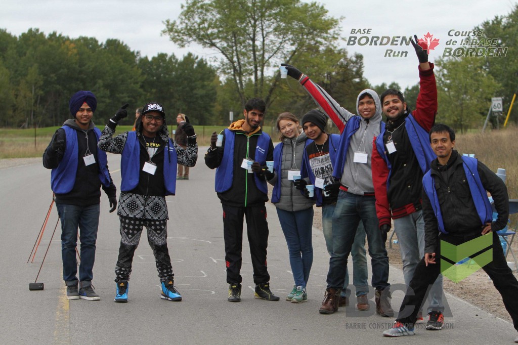 A group of students in running gear cheer themselves on.