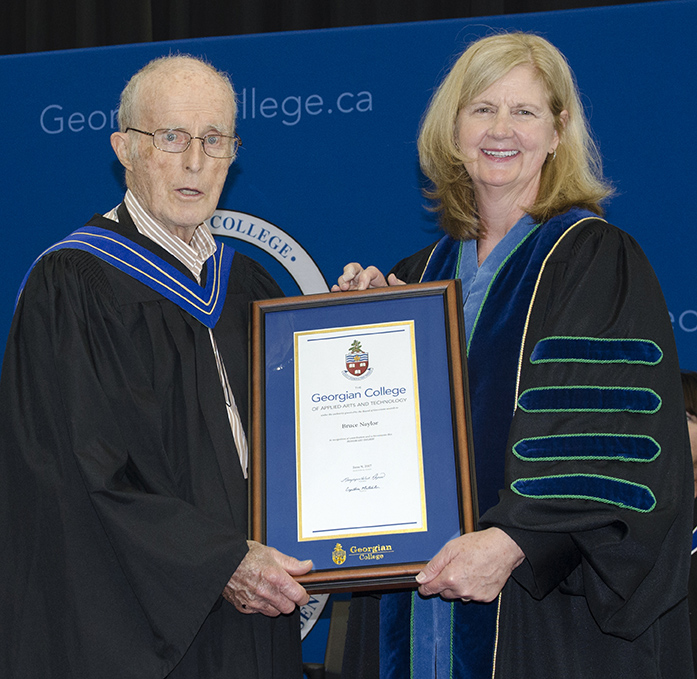 Bruce Naylor receives an Honorary Bachelor of Applied Studies degree from Georgian College President and CEO MaryLynn West-Moynes during Orillia Campus convocation ceremonies on June 9, 2017.