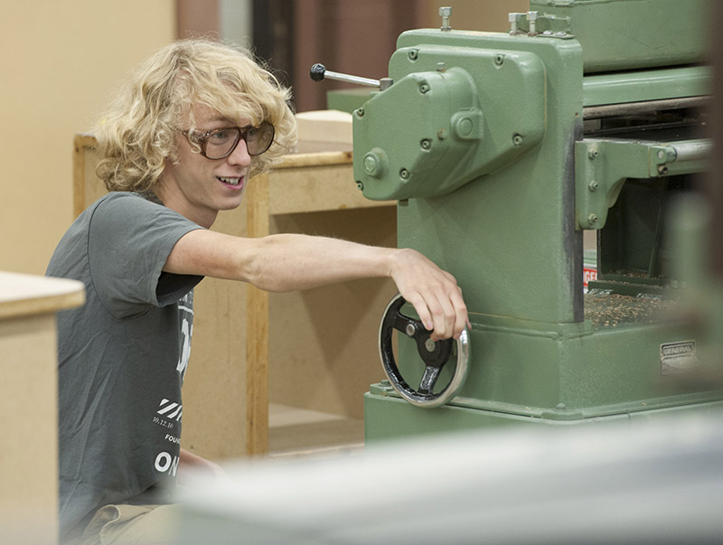 Cabinetmaking student using a piece of machinery