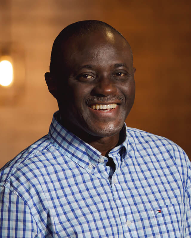 A person smiles at the camera.