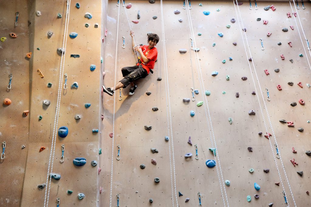 Student using climbing wall
