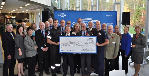 Georgian College and County of Simcoe Council members are pictured holding a $500,000 cheque