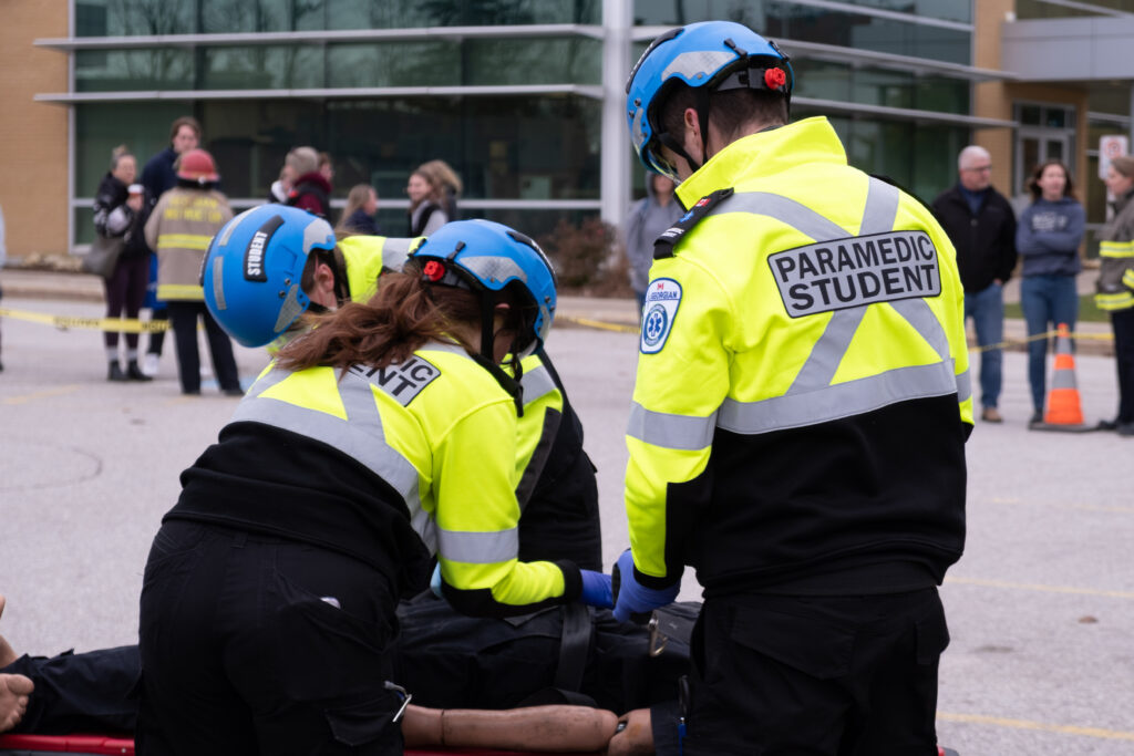 Paramedic students simulate a scenario.