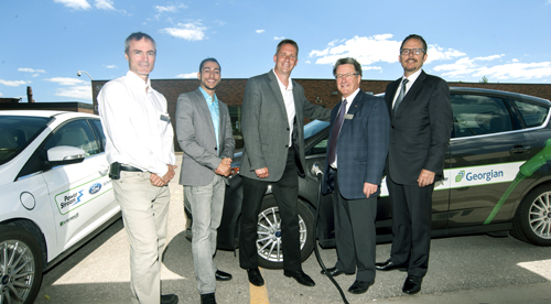 Georgian professor, student, two Ford representatives and Chair of Georgian's Board of Governors stand in front of two Ford electric vehicles