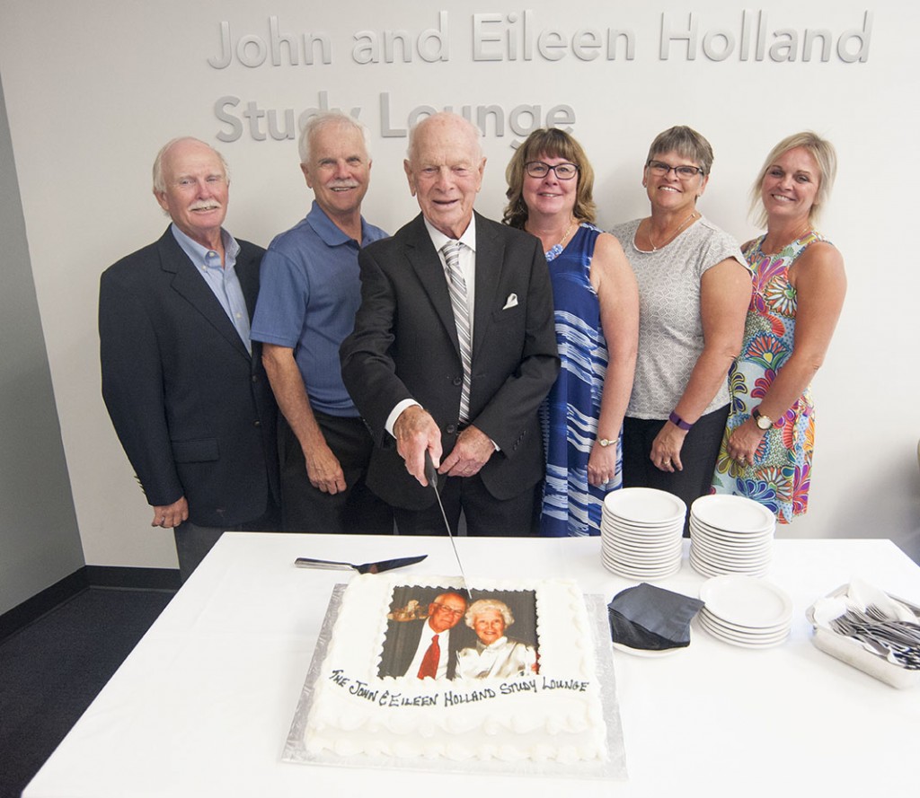 John Holland celebrates the opening of the John and Eileen Holland Study Lounge in Automotive Business School of Canada.