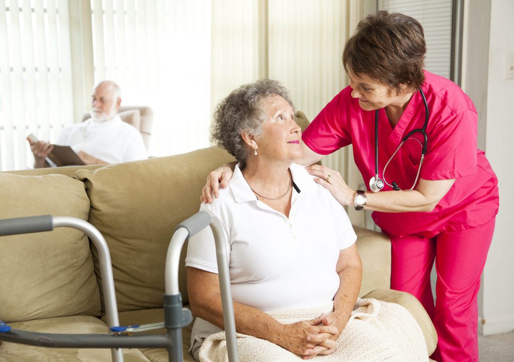 Female PSW taking care of a female patient in a long-term care facility