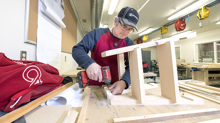 Georgian-Muskoka-Carpentry-and-Renovation-Techniques-student-Bruce-McIntosh-works-on-small-bench-in-shop-space