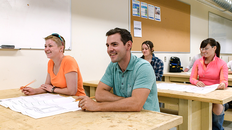 Georgian-Muskoka-construction-trades-pre-apprenticeship-students-Rikki-Austin-and-Meaghan-Edge-smile-in-classroom