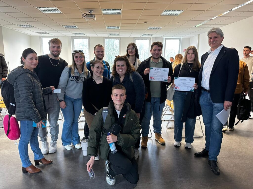 Group of students receiving certificate of participation for International Business Week in Germany