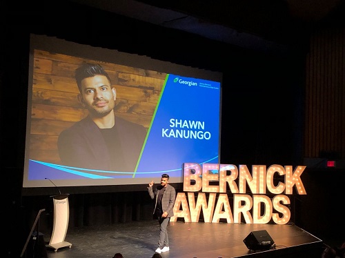 Shawn Kanungo on stage presenting at Bernick Awards