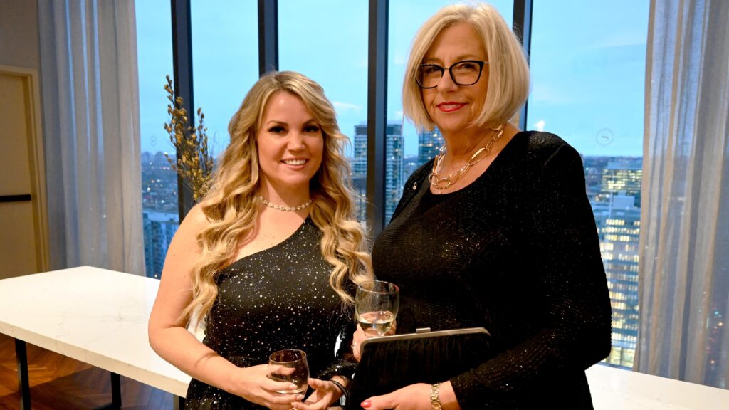 Holly Martin (class of 2014), a Personal Support Worker alumna (right), with fellow alumna Amanda Baysarowich (class of 2006 and 2008) and Alumni Association Executive Council member (left), who presented each nominee with a Grizzly scarf at the Premier's Awards reception.