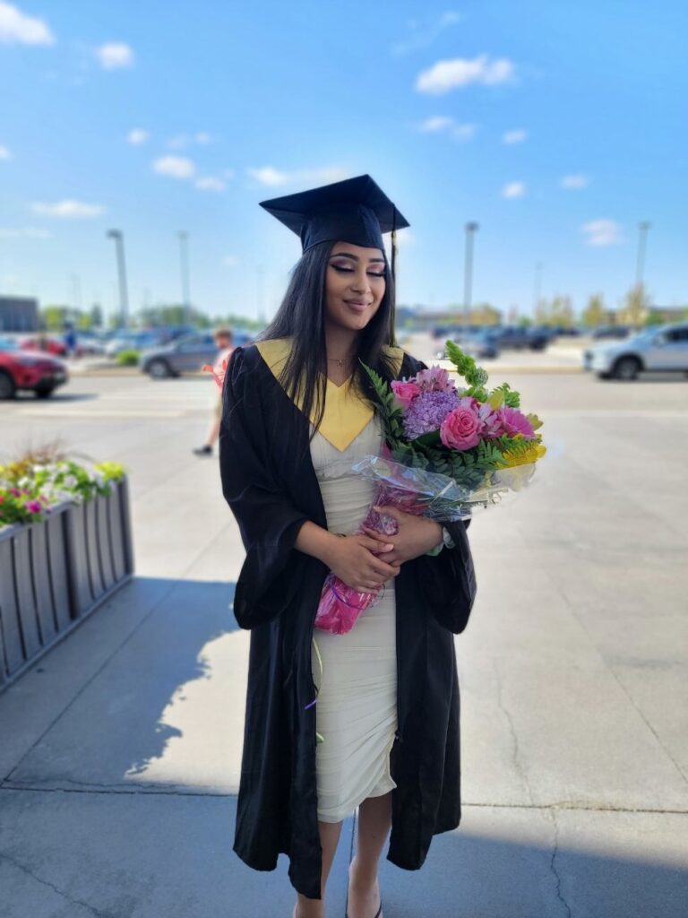 A student wearing a graduation cap and gown.