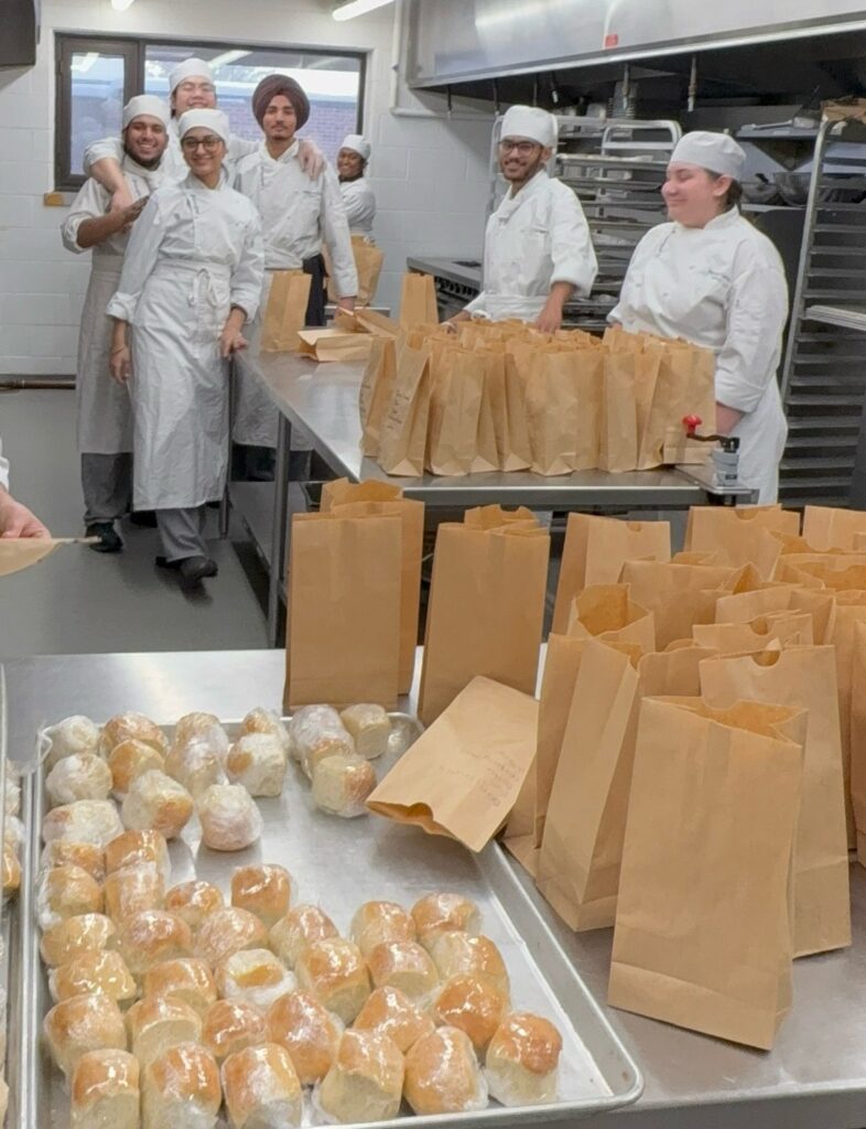 Georgian culinary students pose together while preparing holiday meals.