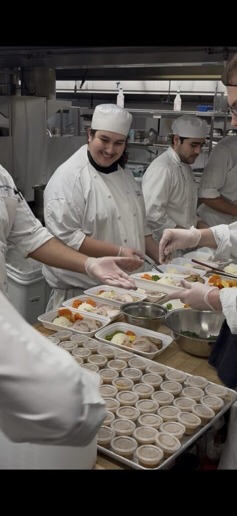 Georgian Culinary student Samir Achahan preapres meals for unhoused members of his community.