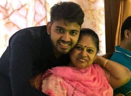 Two people embrace and smile at a camera.