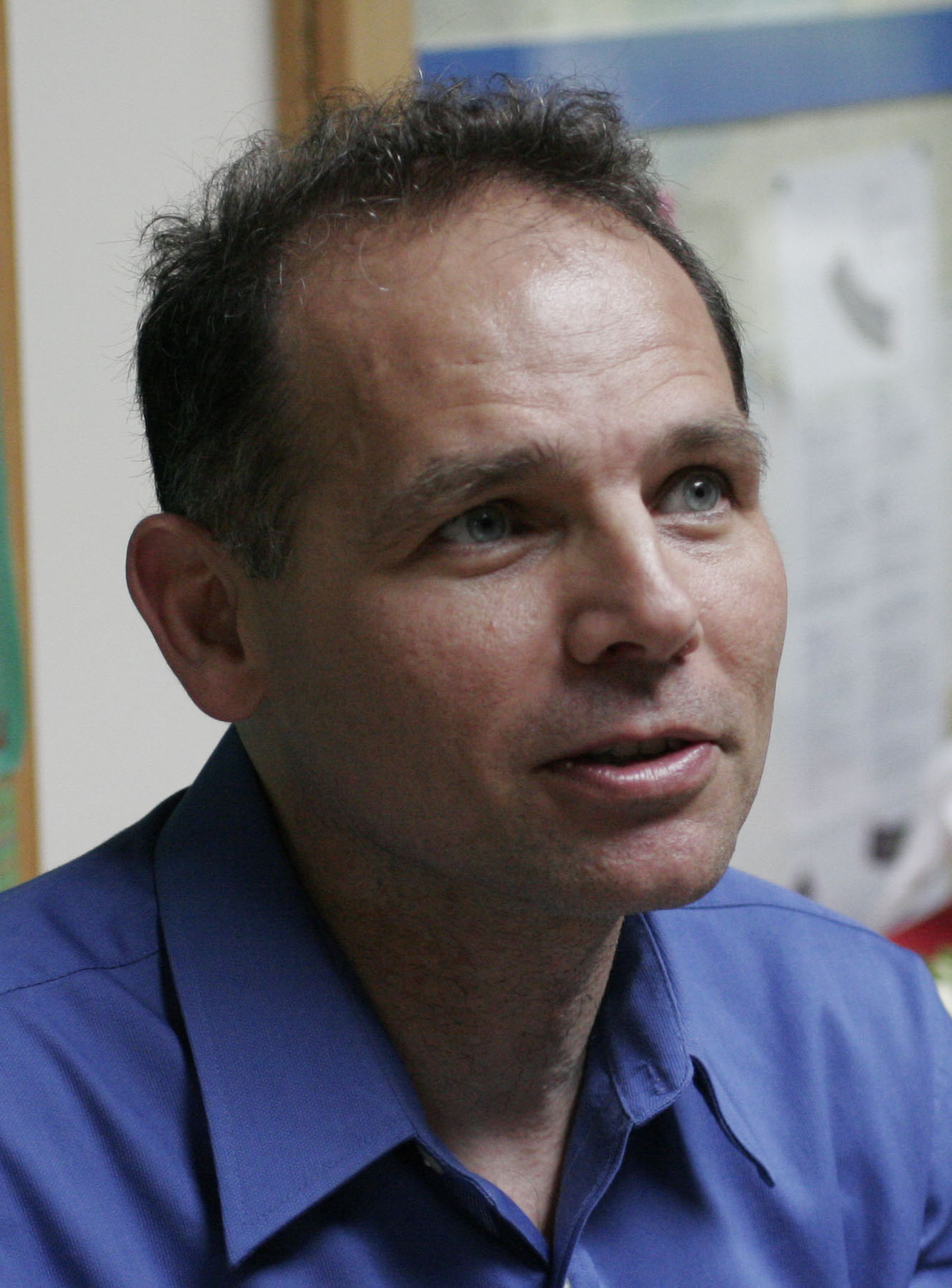 Jim with a blue shirt looking away 