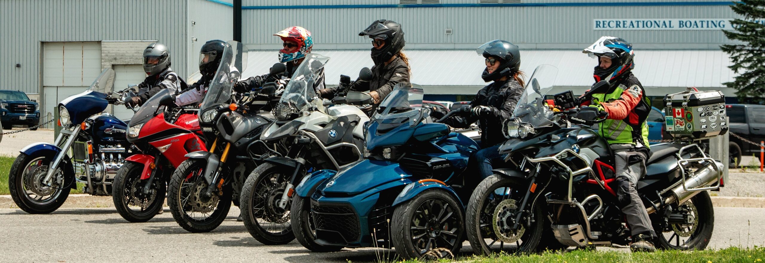 Six people sitting on motorcycles looking forward.