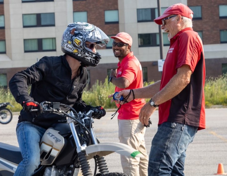 Instructors and student laughing