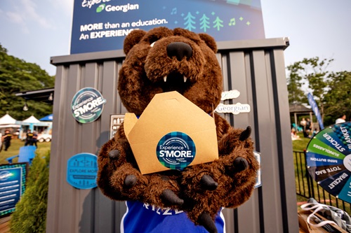 Tall Pines Festival - Growler, our Grizzly mascot, holds up a S'MORE container