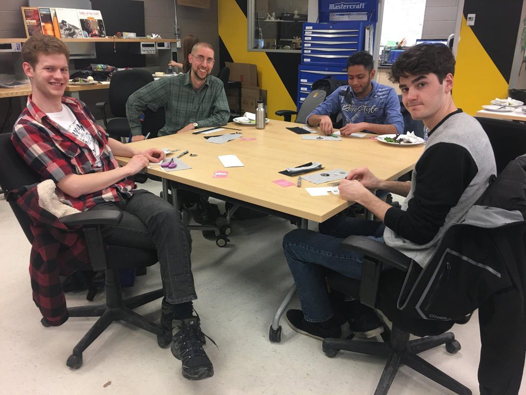 Students making items around a table