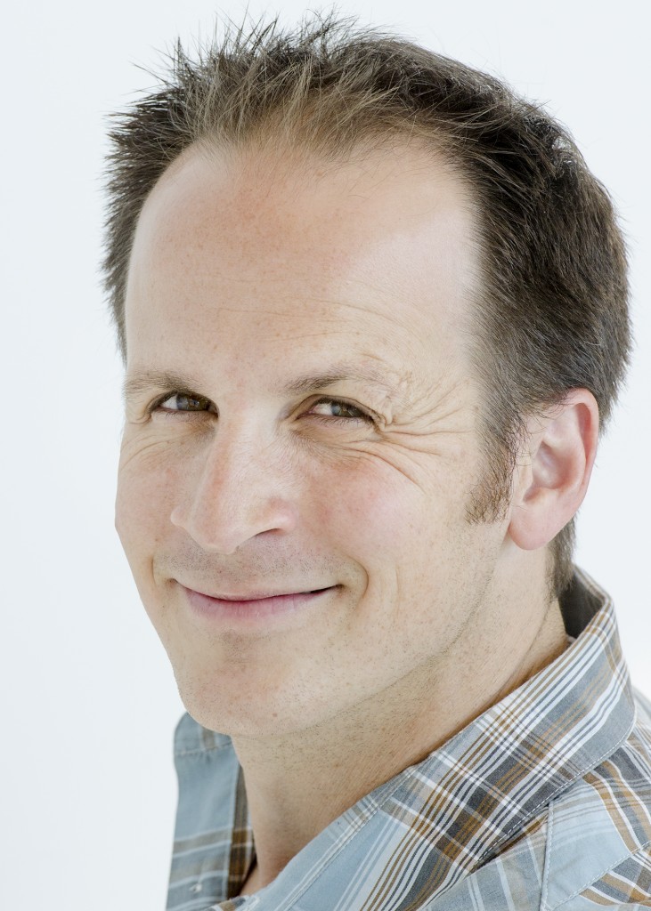 Matt smiling headshot in a white background