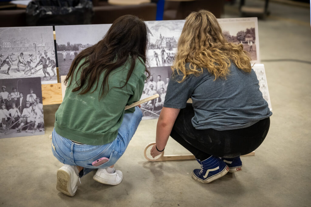 Two students looking at historical photos.