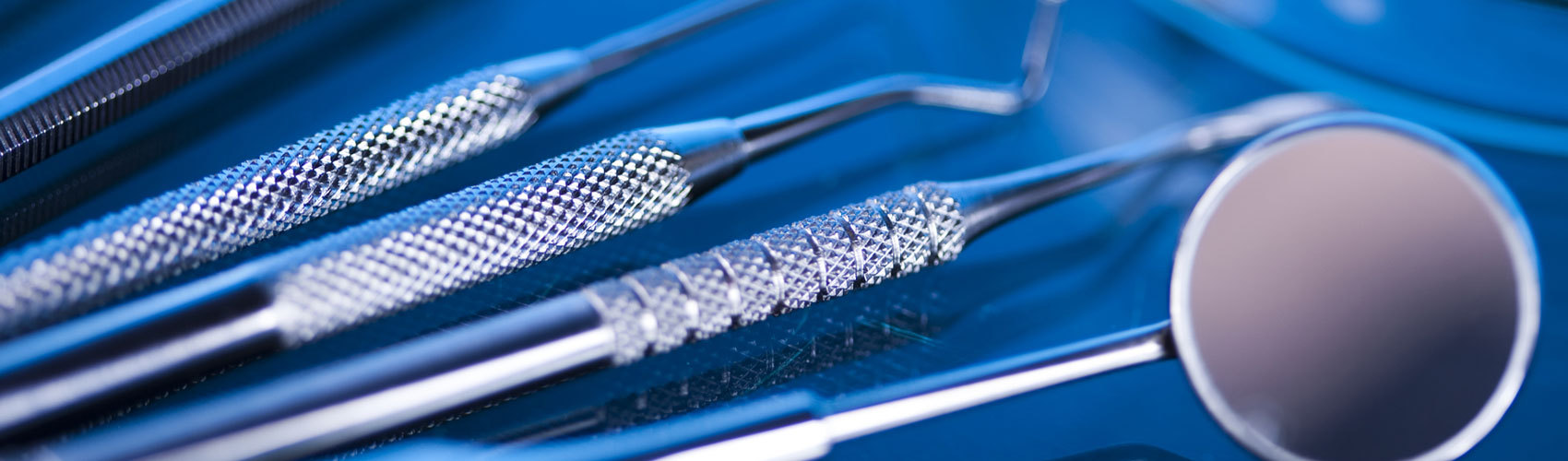 Dental tools on navy blue background