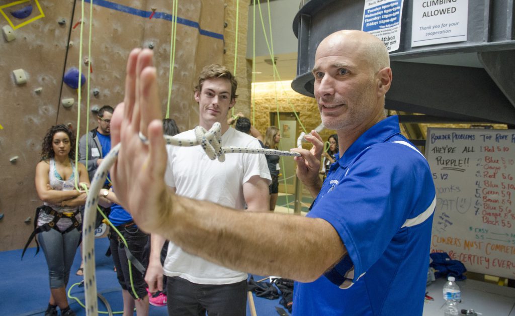 Man showing knot techniques for the climbing wall
