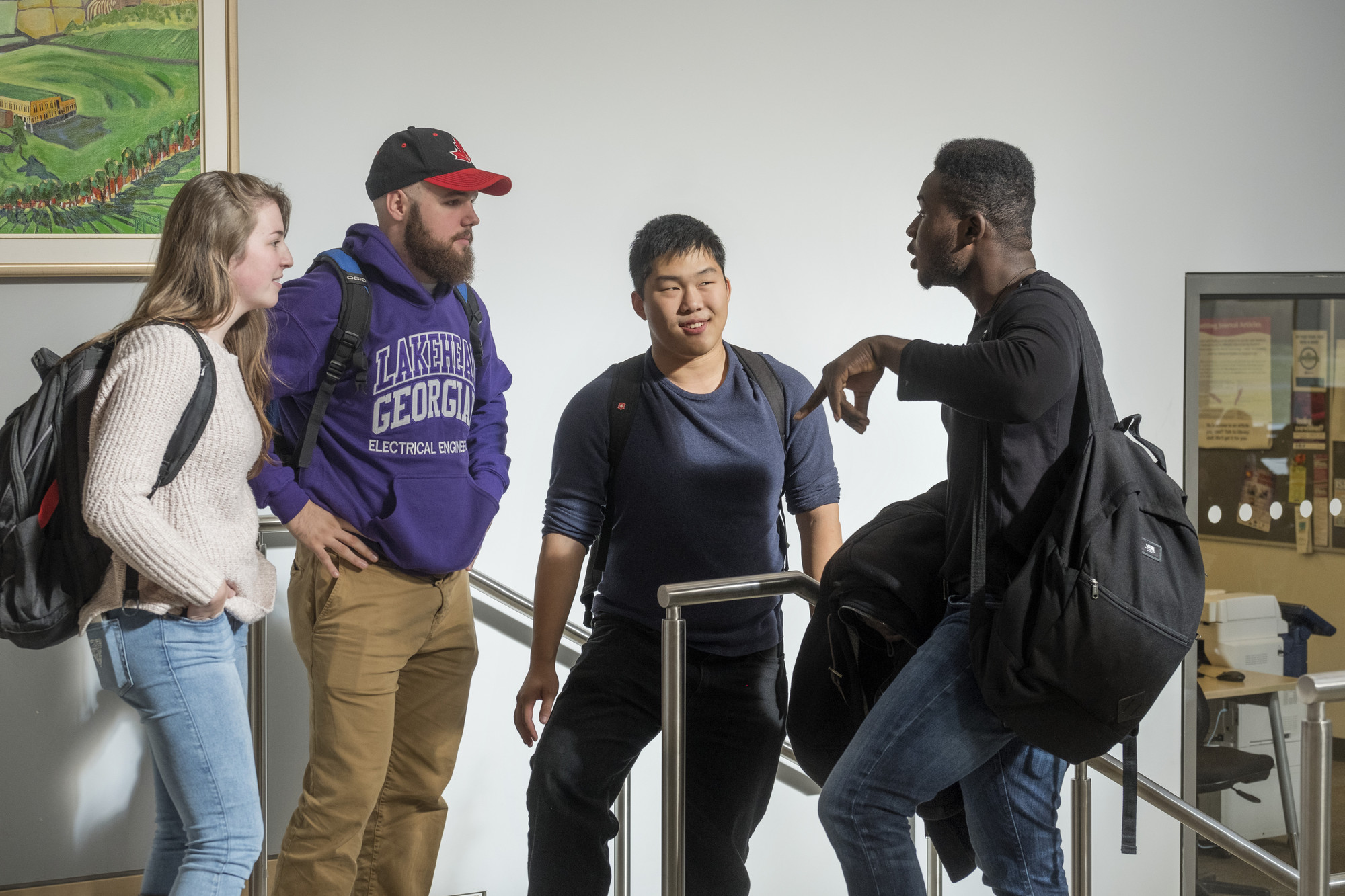 4 students from Lakehead-Georgian talking in the hall