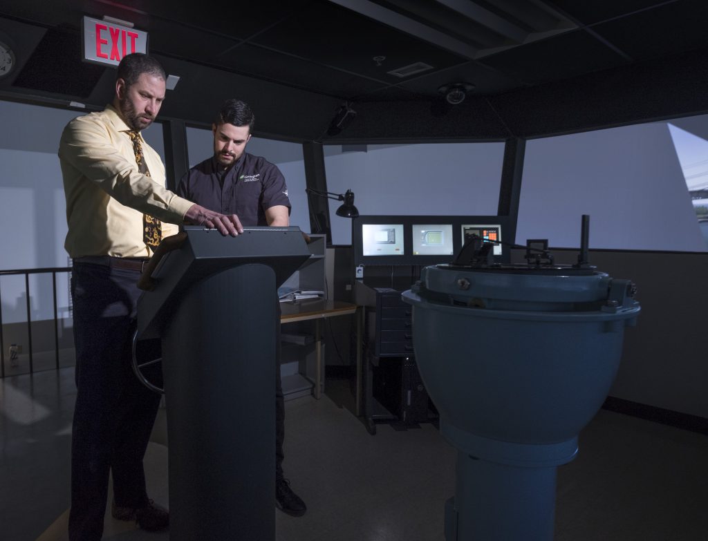 A student and faculty working on marine navigation