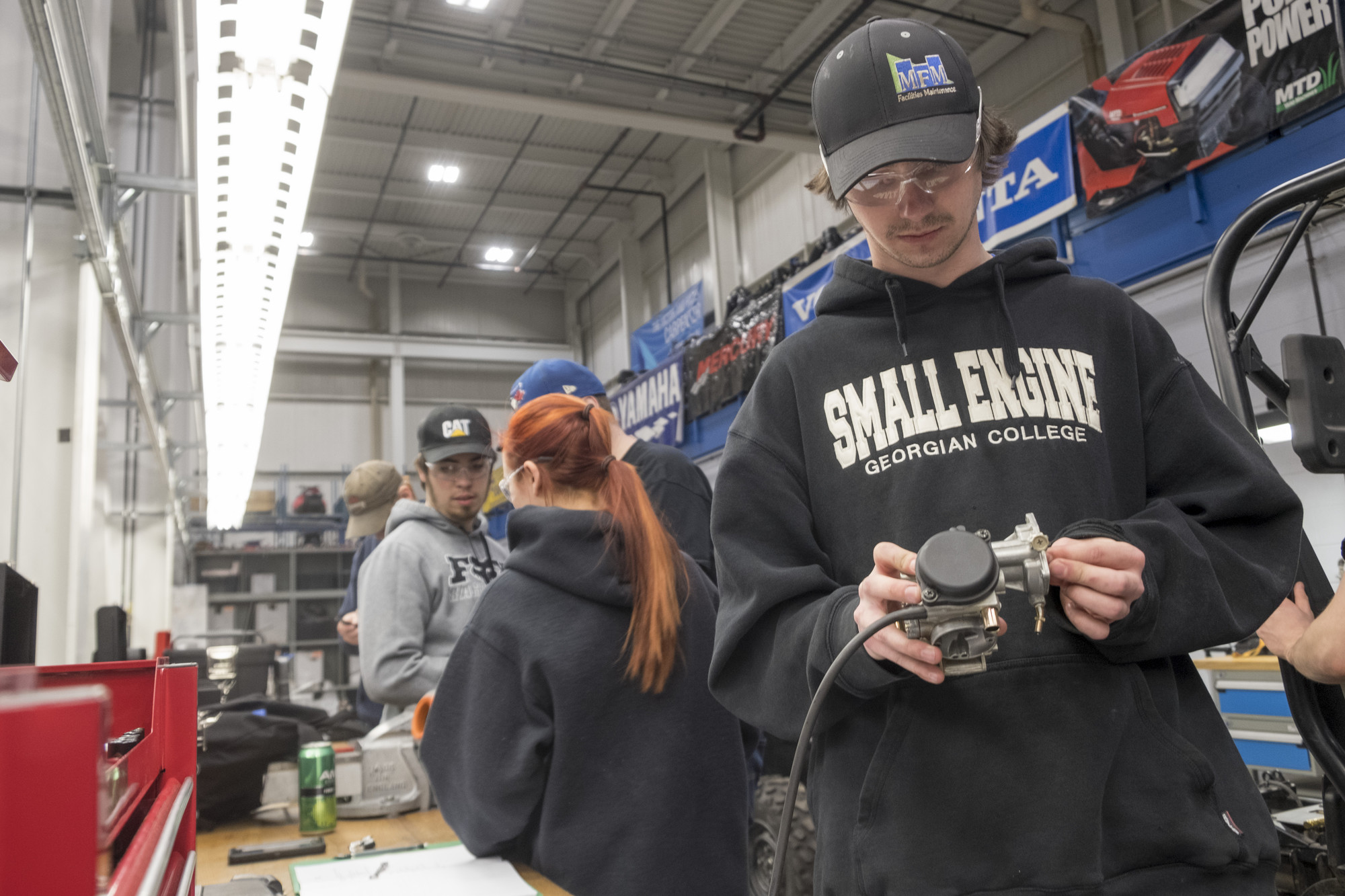 Marine Small Engine Mechanic students working in the shop