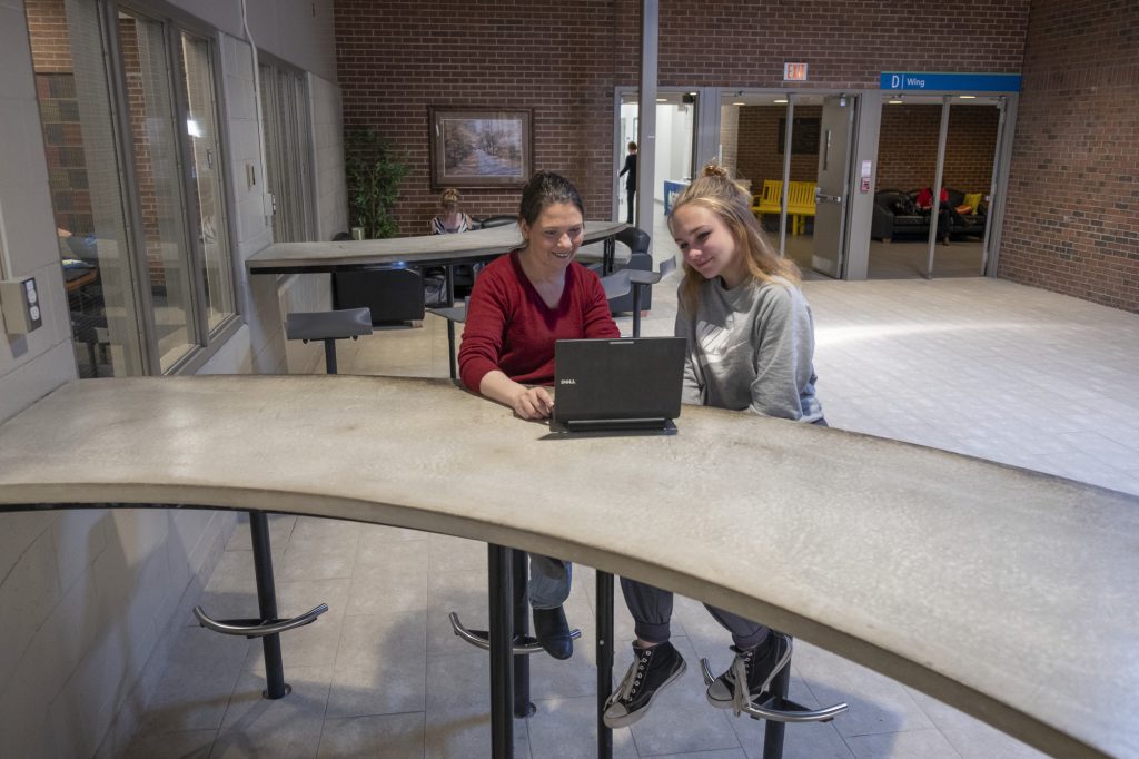 2 female students working on a laptop at the Owen Sound Campus