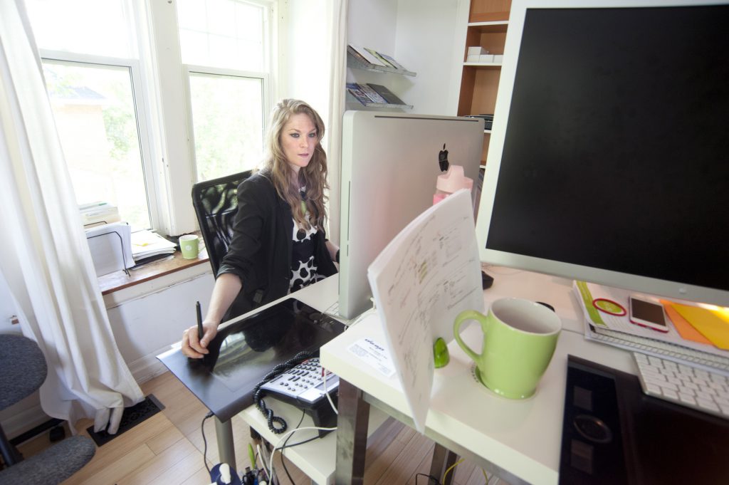 Graphic Designer working on Mac Book