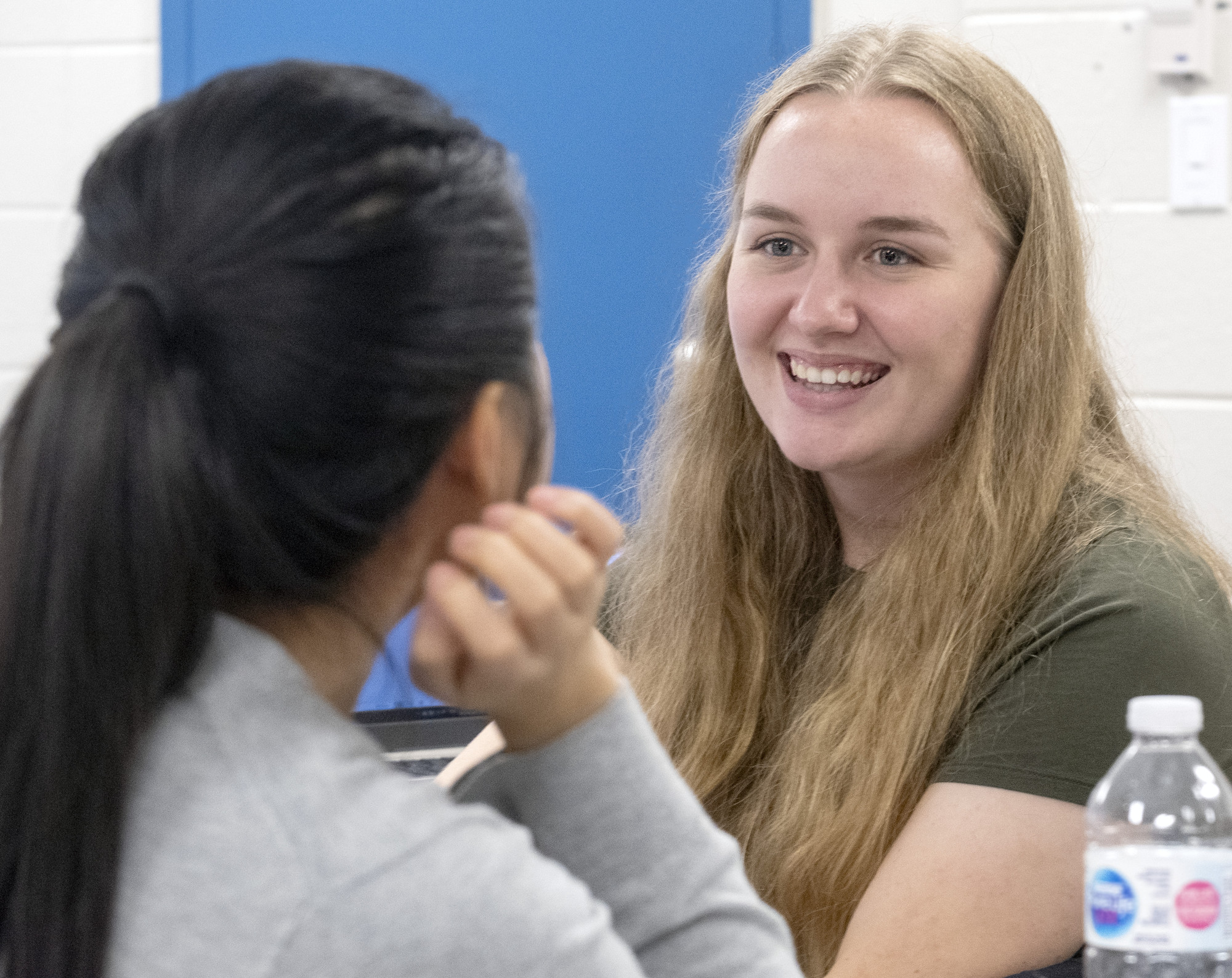 Two students in class sitting across from each other