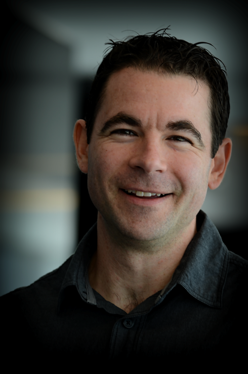 Rich smiling and wearing a black shirt