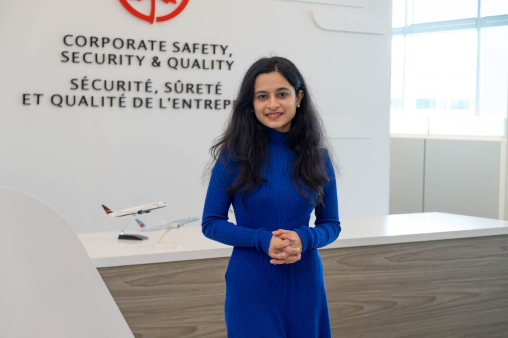 A student standing in front of a desk at Air Canada.