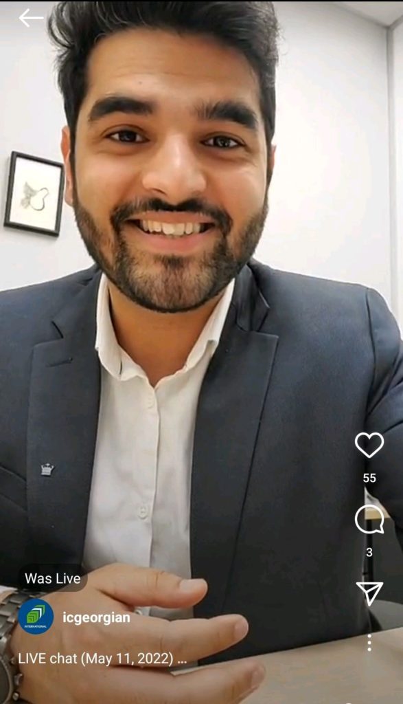 A screenshot of a person smiling and wearing a suit during an Instagram live chat.
