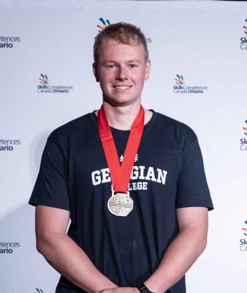 Logan with his gold medal at Skills Ontario.