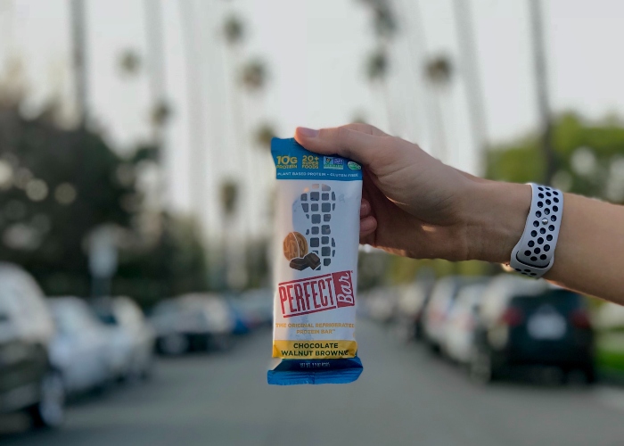 A hand holding a snack bar