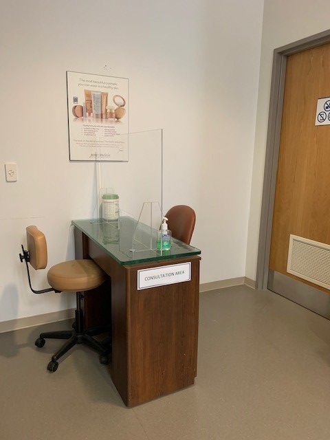 spa client consult area with sneeze guard to stop the spread of COVID0-19.