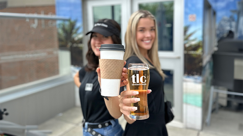 Two TLC staff holding beverages