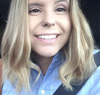 Tyea Romas - School Within a College, dual credit grad, selfie of young woman in car wearing seatbelt, smiling, medium length blonde hair